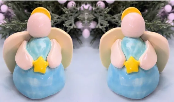Two handmade pinch pot angels created from clay during a Sunshine Studios art class.