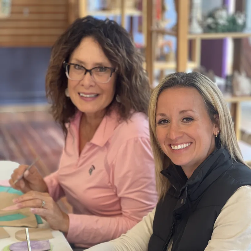 Two individuals smiling