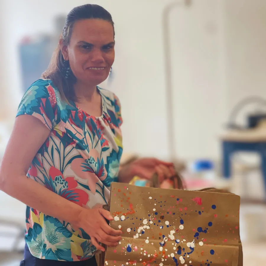 Angela holding up her art