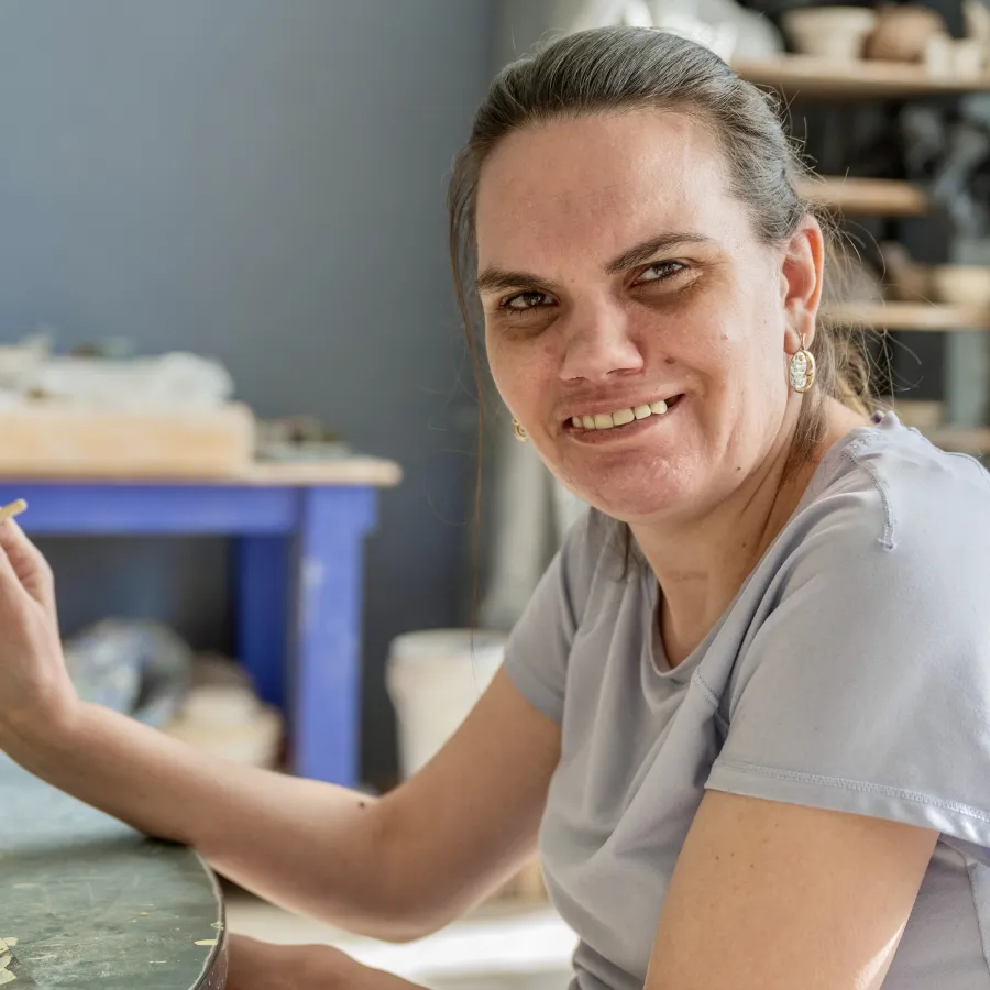 Angela holding up her art